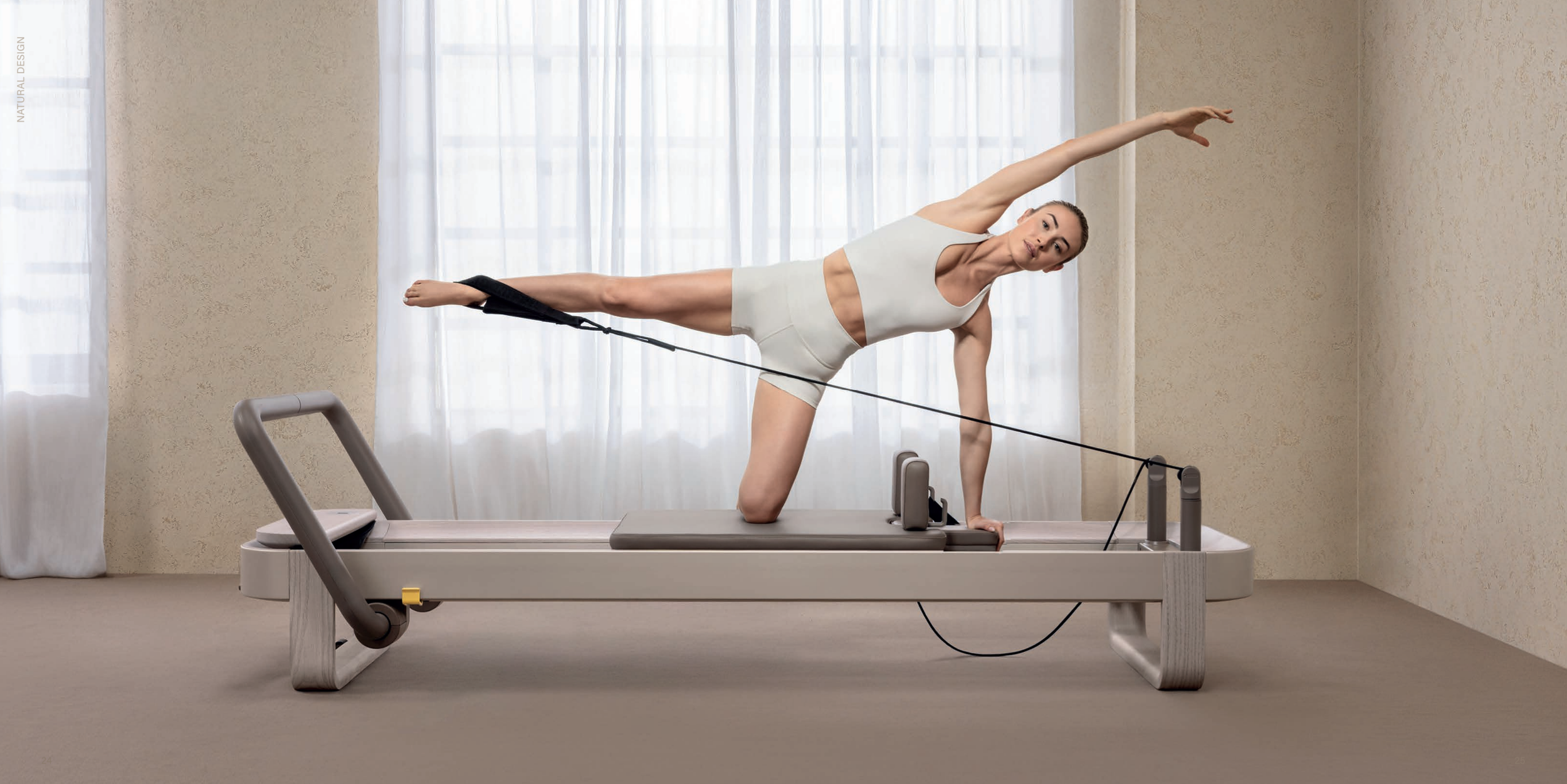 technogym luxury sandstone pilates reformer in use.png