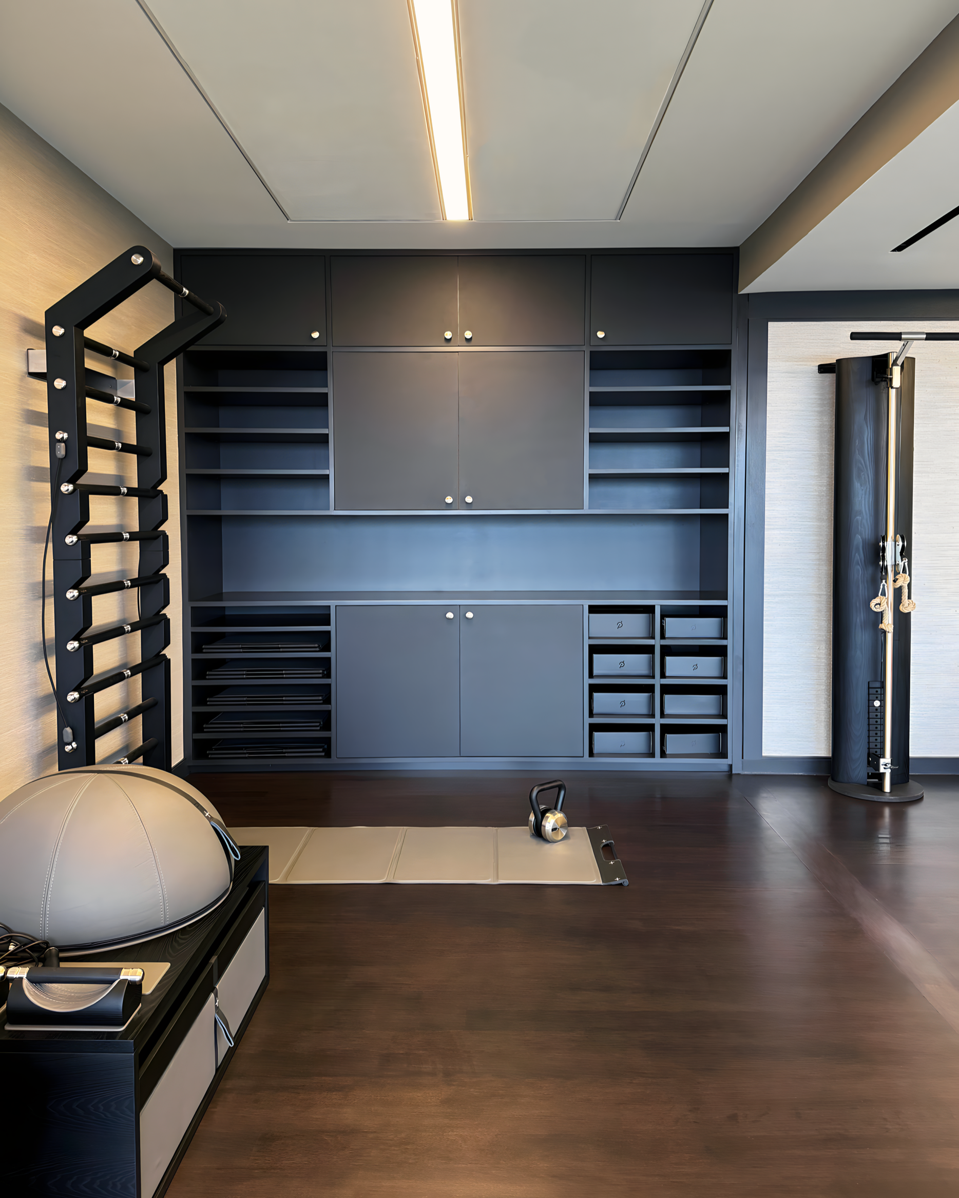 built-in_storage_for_fitness_mats_and_peloton_shoes.png