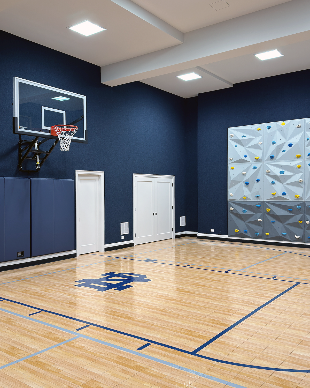 Home gym basketball court with rock wall.png