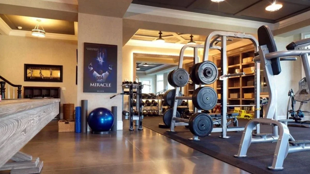 Luxury home gym with DuraTrain rubber flooring supporting heavy strength equipment in a private training space