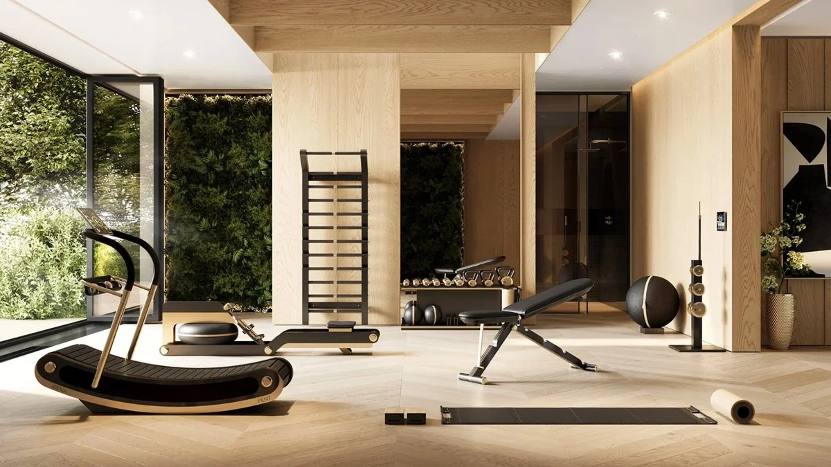 Luxury home gym with PENT Fitness equipment featuring black, wood, and brushed gold finishes in a minimalist wellness space
