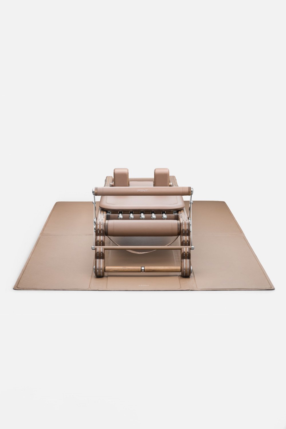 PENT JOANA luxury pilates reformer on a leather mat.