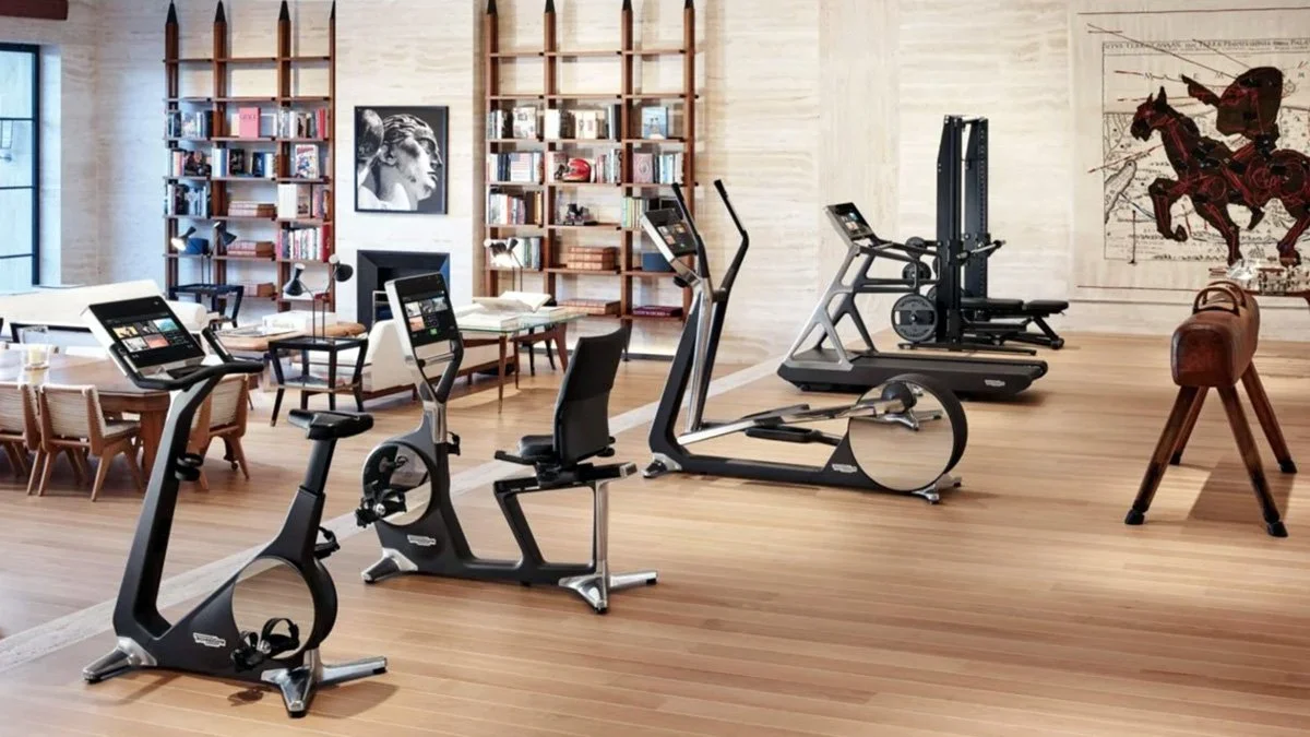 Luxury home gym featuring Technogym Personal Line cardio and strength equipment integrated into a refined residential interior