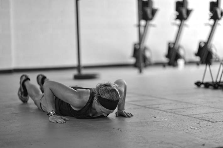 Pam making sure she doesn't get "no repped" for her push-ups. Crossfit push-ups call for the chest to touch the ground every rep.
