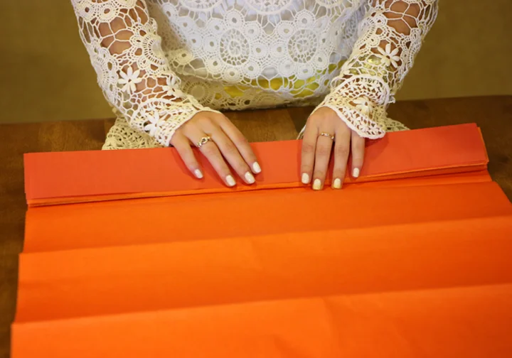 Step 3: Start at one end of your gathered sheets, and start to fold in and out accordion hotdog style. Keep your folds about an inch or so apart for easy maneuvering in the later stages.