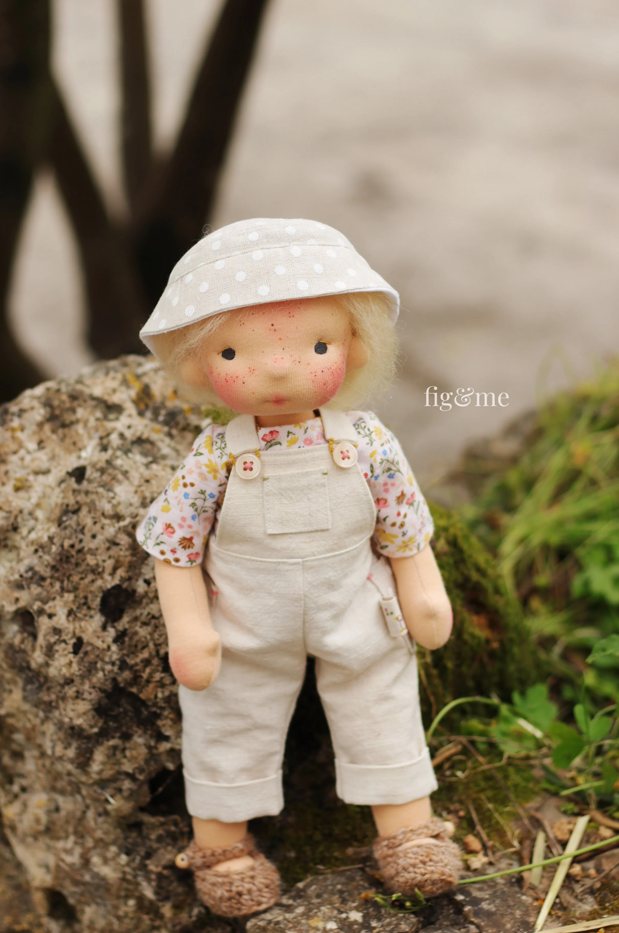 waldorf inspired doll with linen overalls, floral shirt and bucket hat
