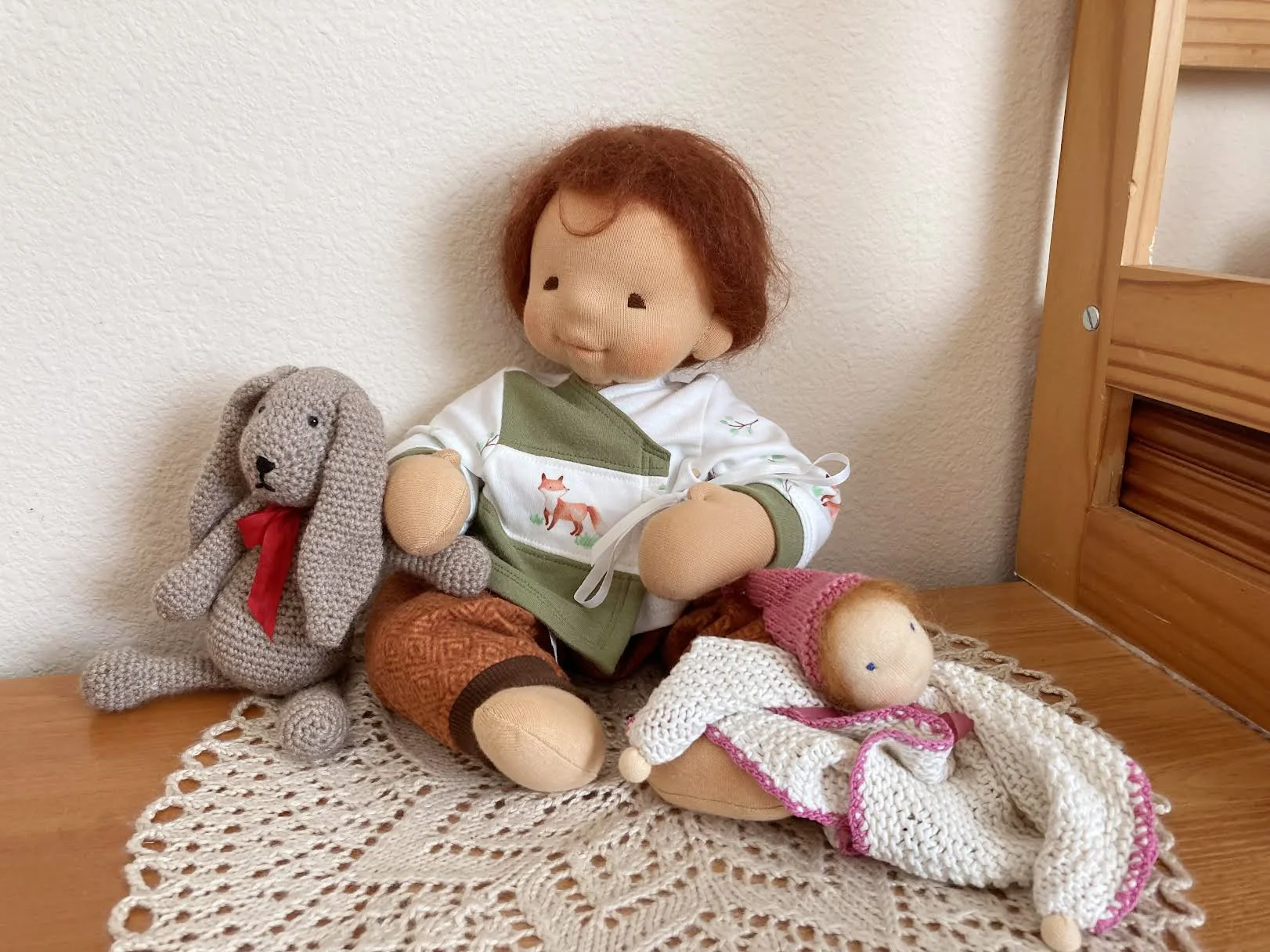 Waldorf inspired baby doll with chestnut hair and handmade toys