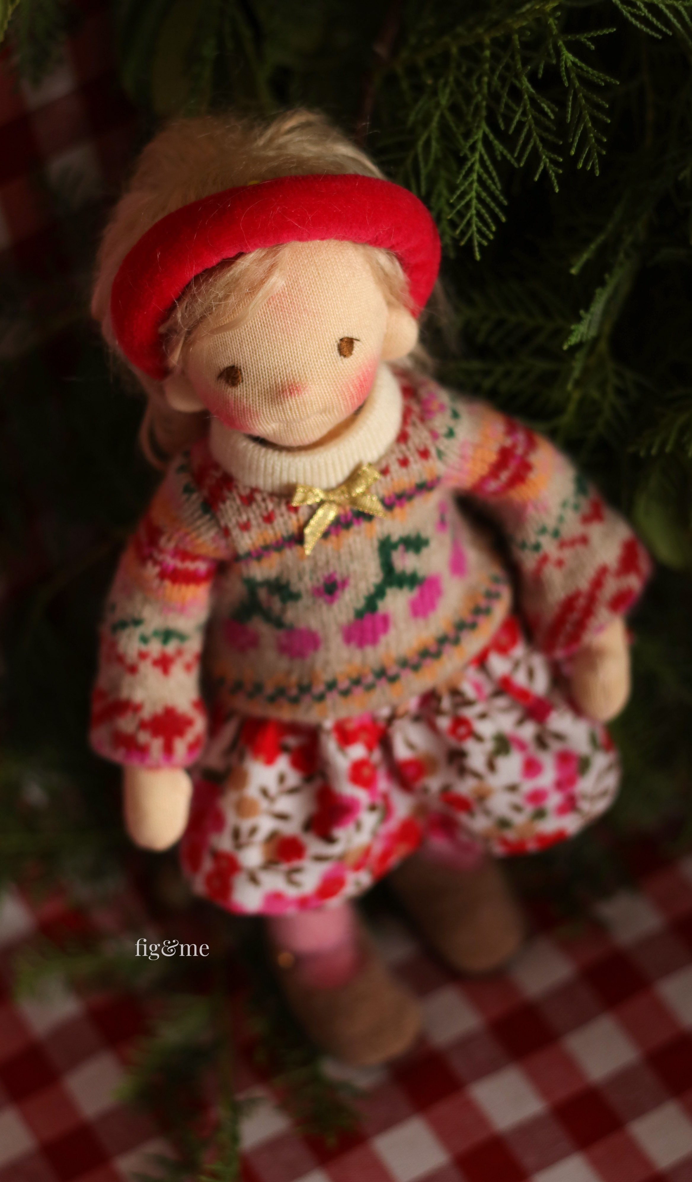 waldorf inspired doll wearing christmas knit clothes