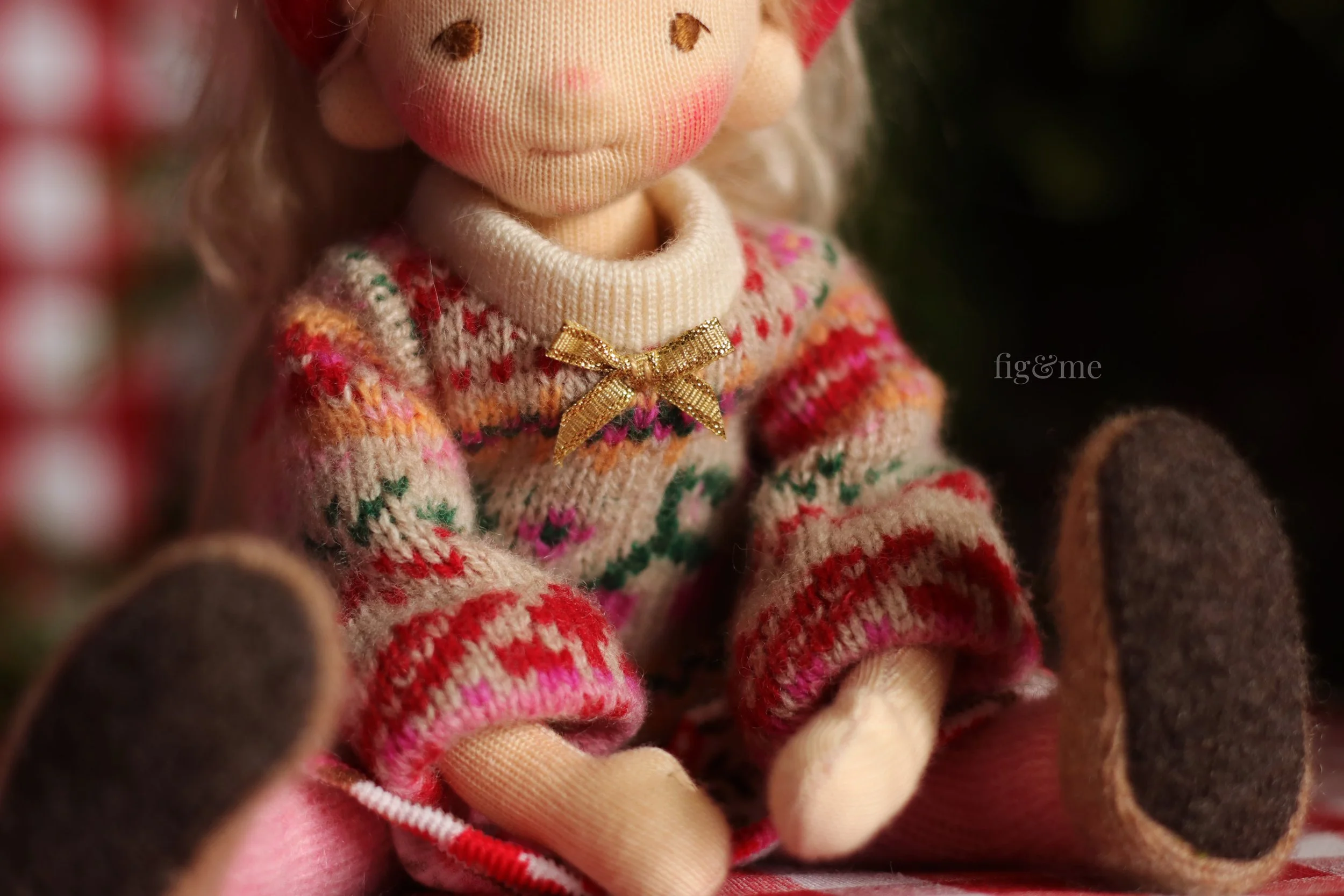 golden bow on doll cardigan