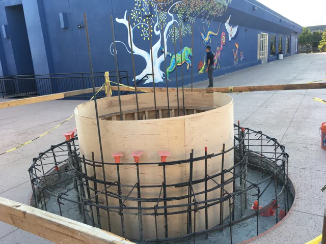 Under construction: the wall and circular seating area where the lizard will live.
