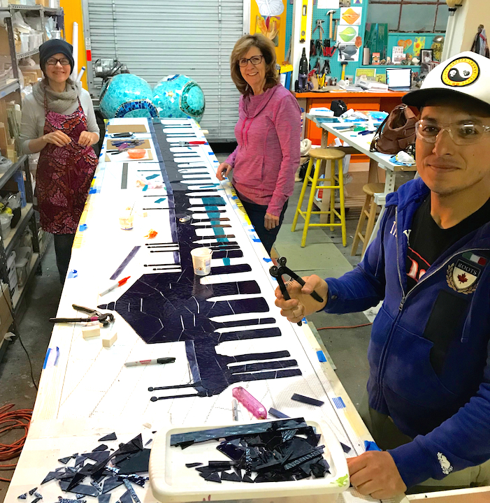 Sophia Othman, Glynnis Kaye and Jesse Medina doing glass work on the Pier Mosaic