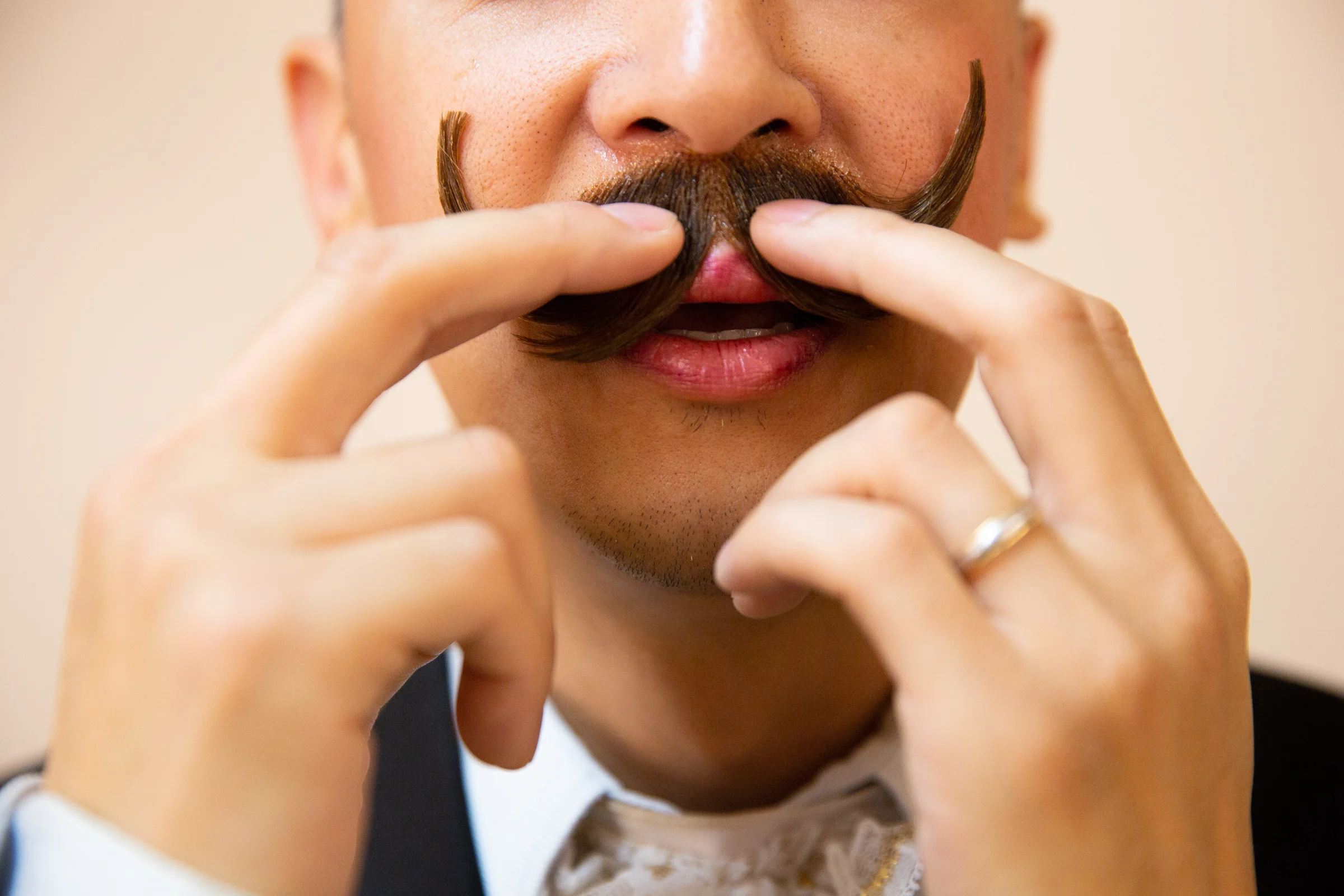 Ernest Hui holds his fake mustache in place while it dries backstage in the men's dressing room for Western Ballet's production of "The Nutcracker" at the Mountain View Center for the Performing Arts on Dec. 2, 2018.