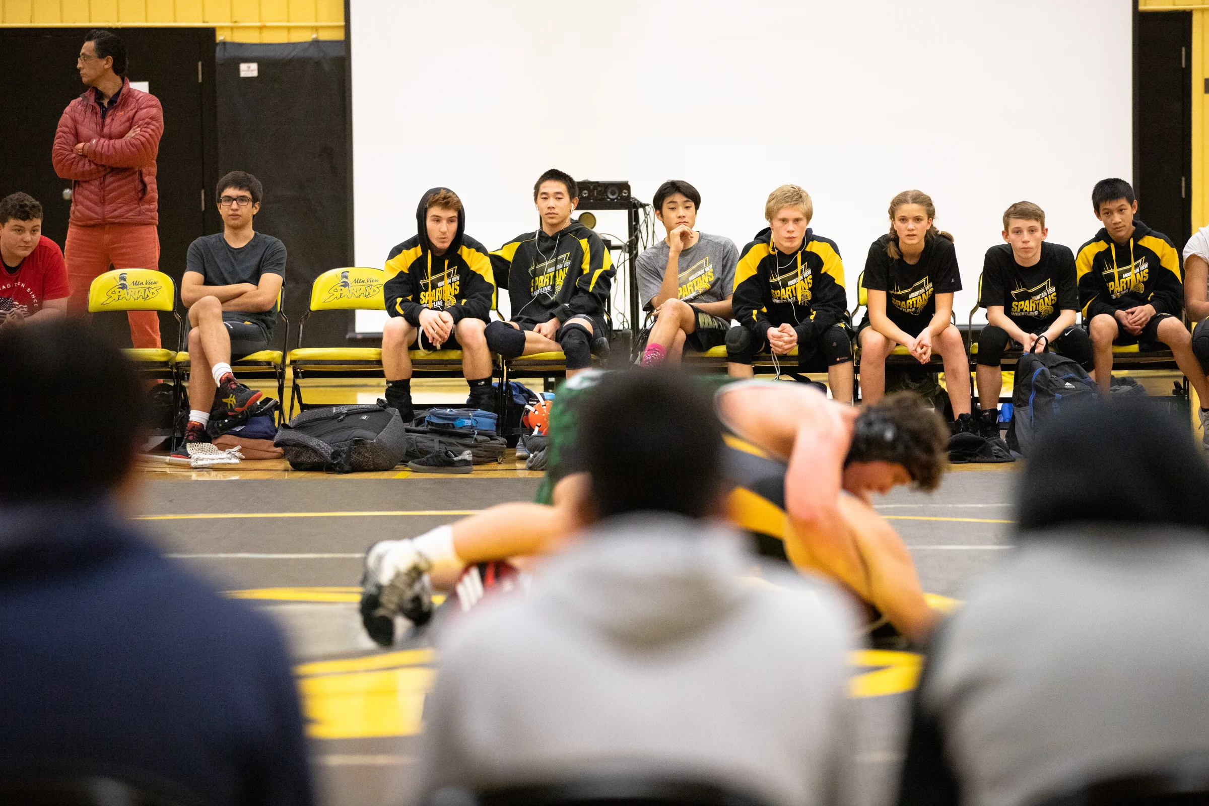 Paris Harrell, 15, is the only female member of Mountain View High School’s wrestling team. She sits with her teammates watching a fight against Homestead High School at a home meet in Mountain View, California, on Jan. 31.
