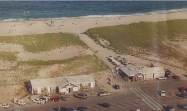 An overhead view of the beach around 1990. Liam's is to the right with tables and umbrellas between it and the beach (bostonglobe.com)