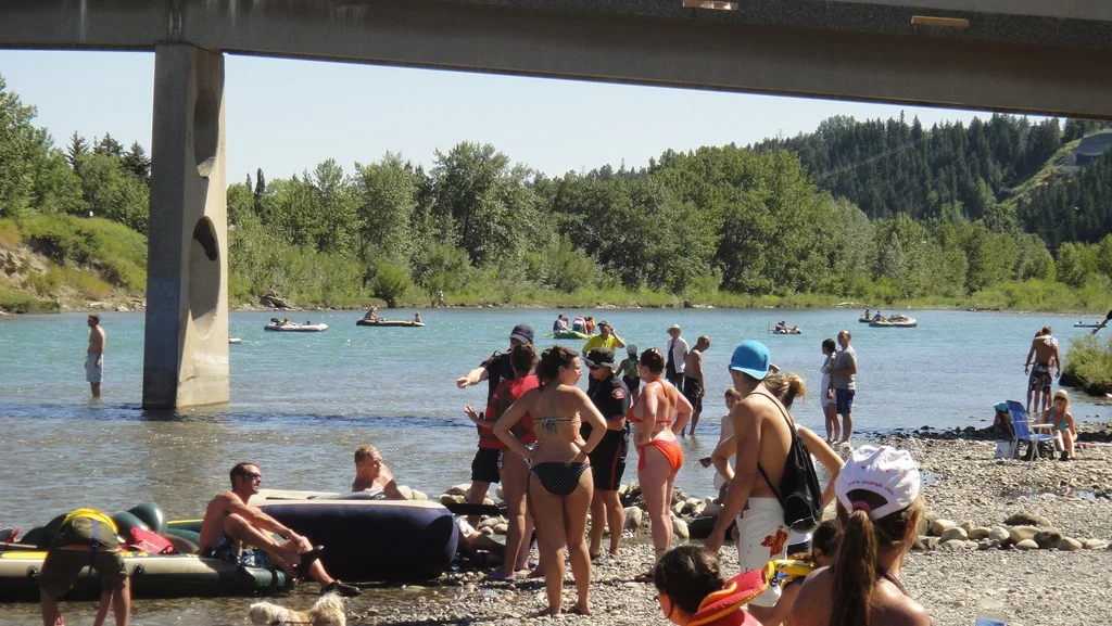Calgarians enjoying pebble beach at Edworthy Park.