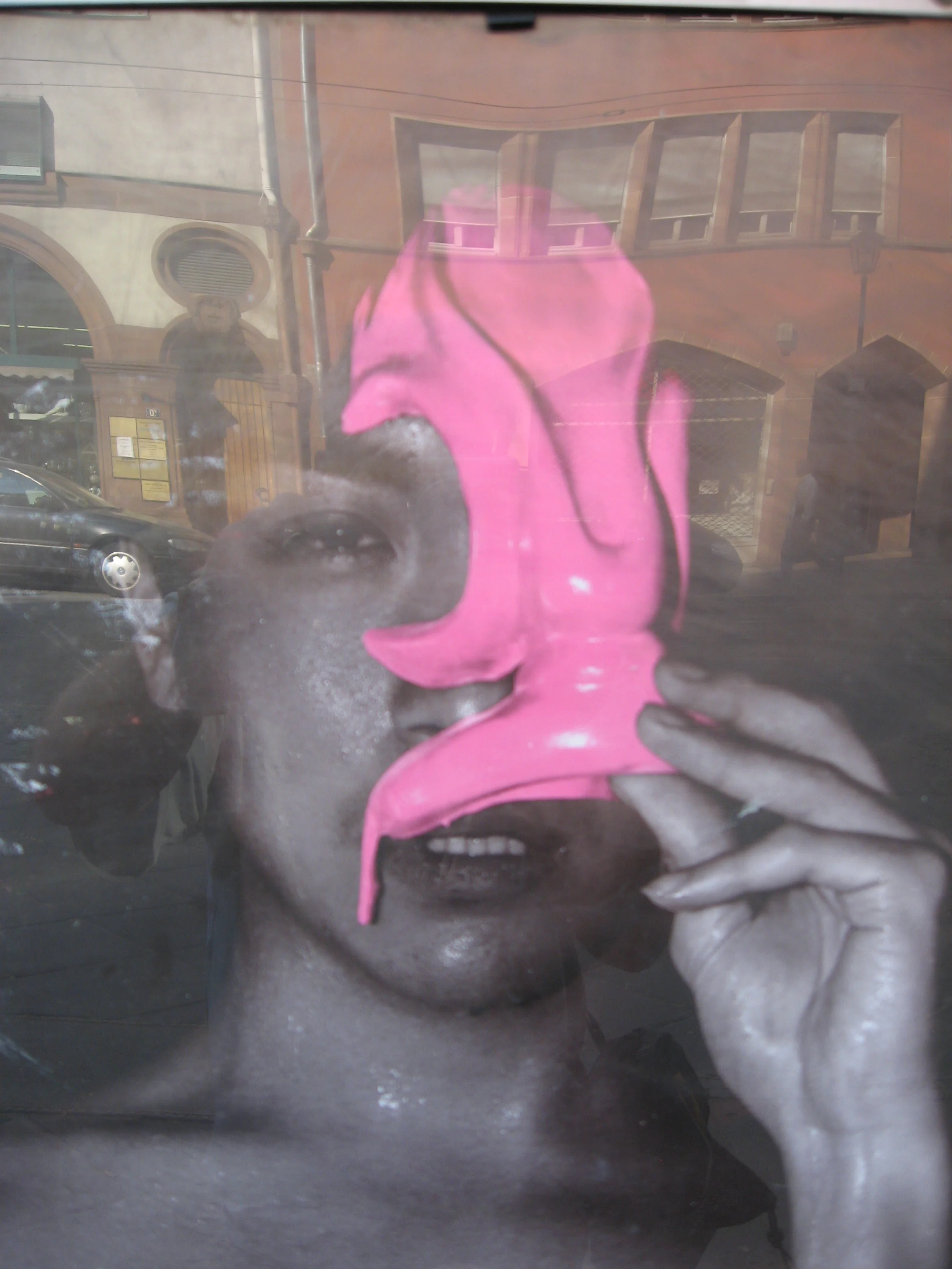 Titled "Mask" this mixed-media work is a reflection of a poster in a window that creates an intriguing layer of images. There is a theatrical quality to this artwork, as if we are all part of performance art piece. 