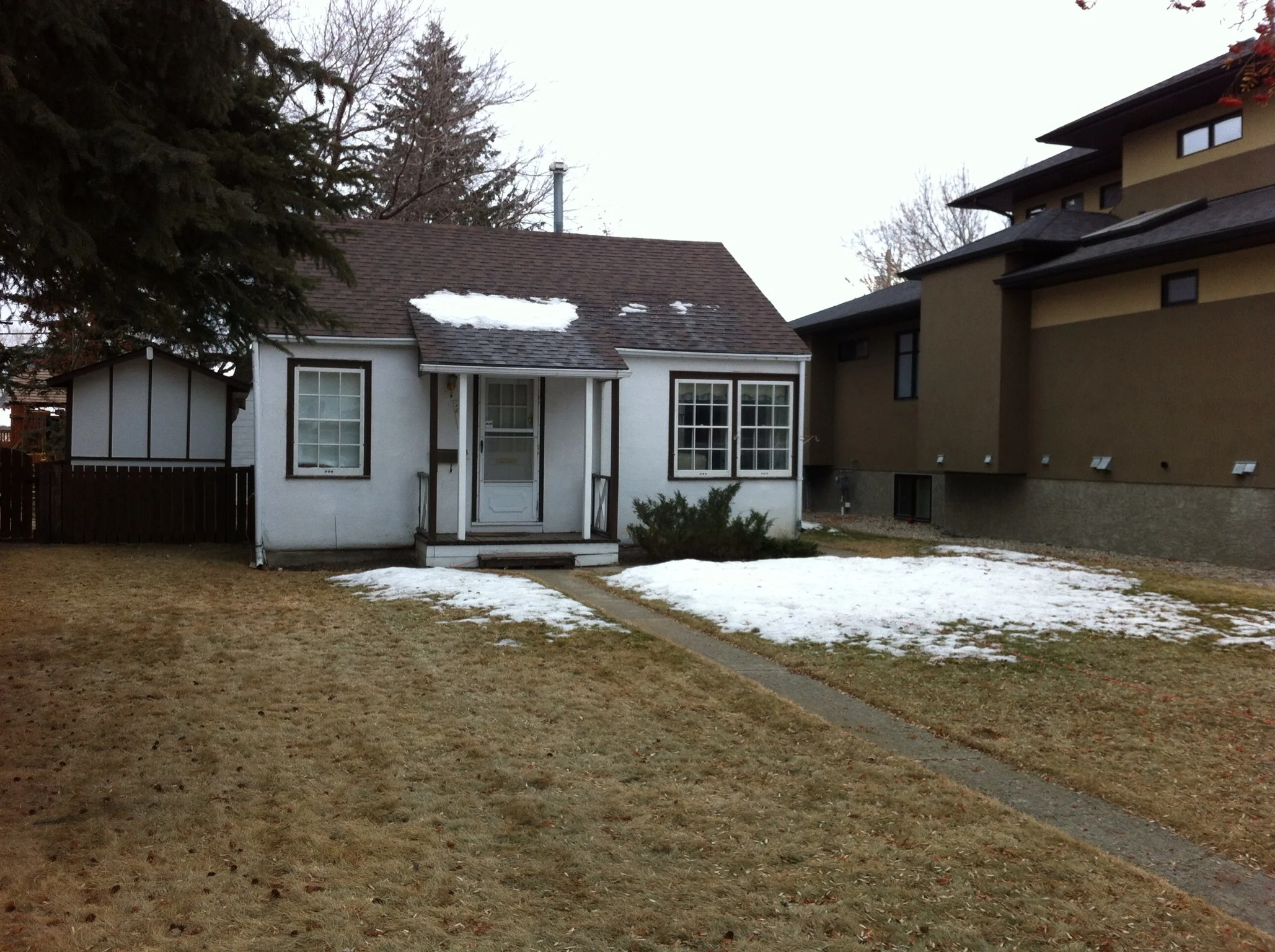 One of the few cottages that are set back from the street. You really get a sense of how small they are. You can see the monster mansion that has been built next door.