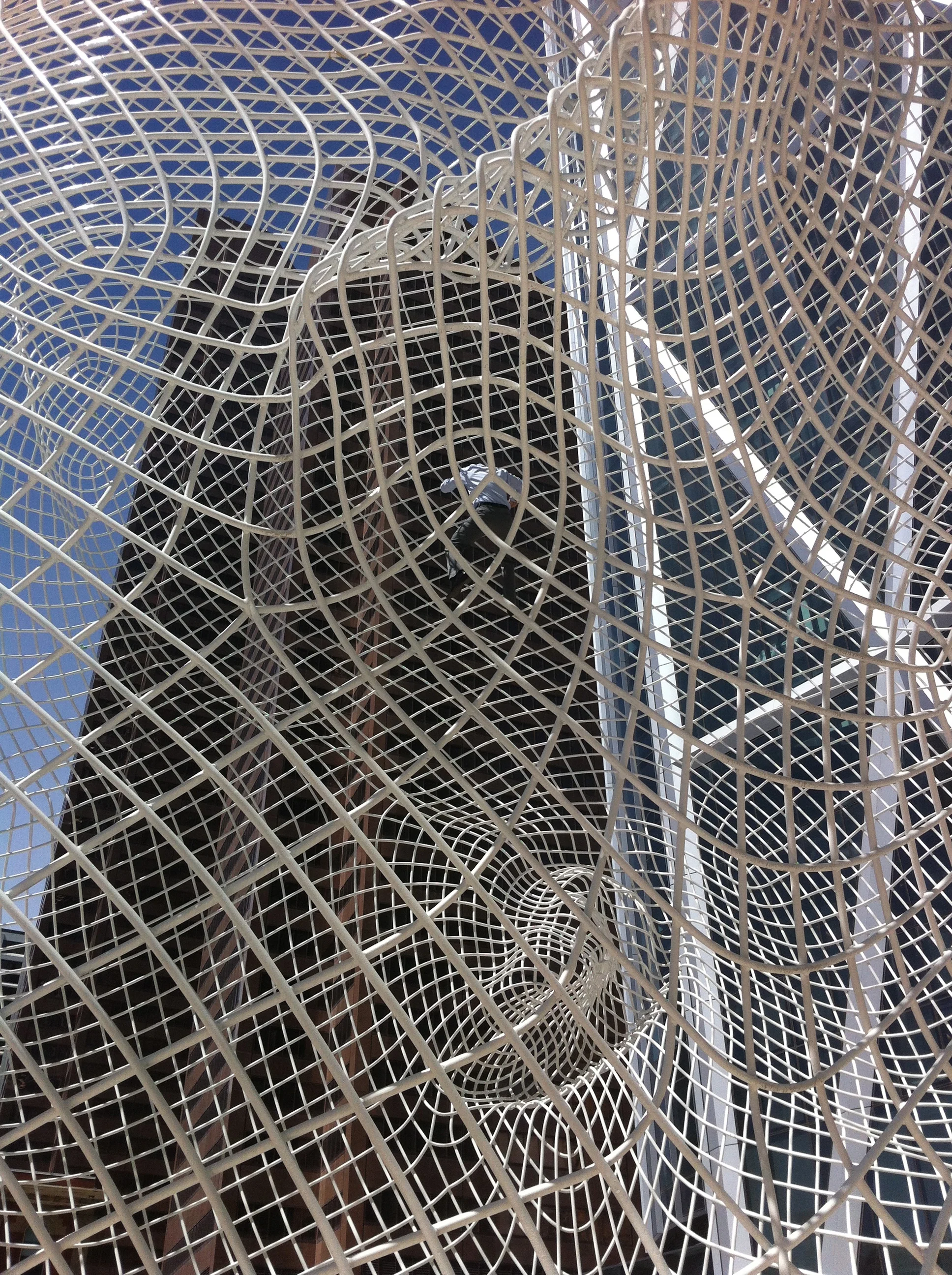 Wonderland by famous Spanish artist Jaume Plensa is a wire sculpture of the head of a young girl on the plaza in front of the Bow office tower by renown architect Norman Foster. This ghost-like representational figure piece has been widely praised by professionals and public. It is a fun piece to go inside and look at the downtown skyline through the maze of lines created by the skull form. One local businessman, in his street shoes and clothes decided to climb it, turning it into a playground climbing sculpture for adults. 