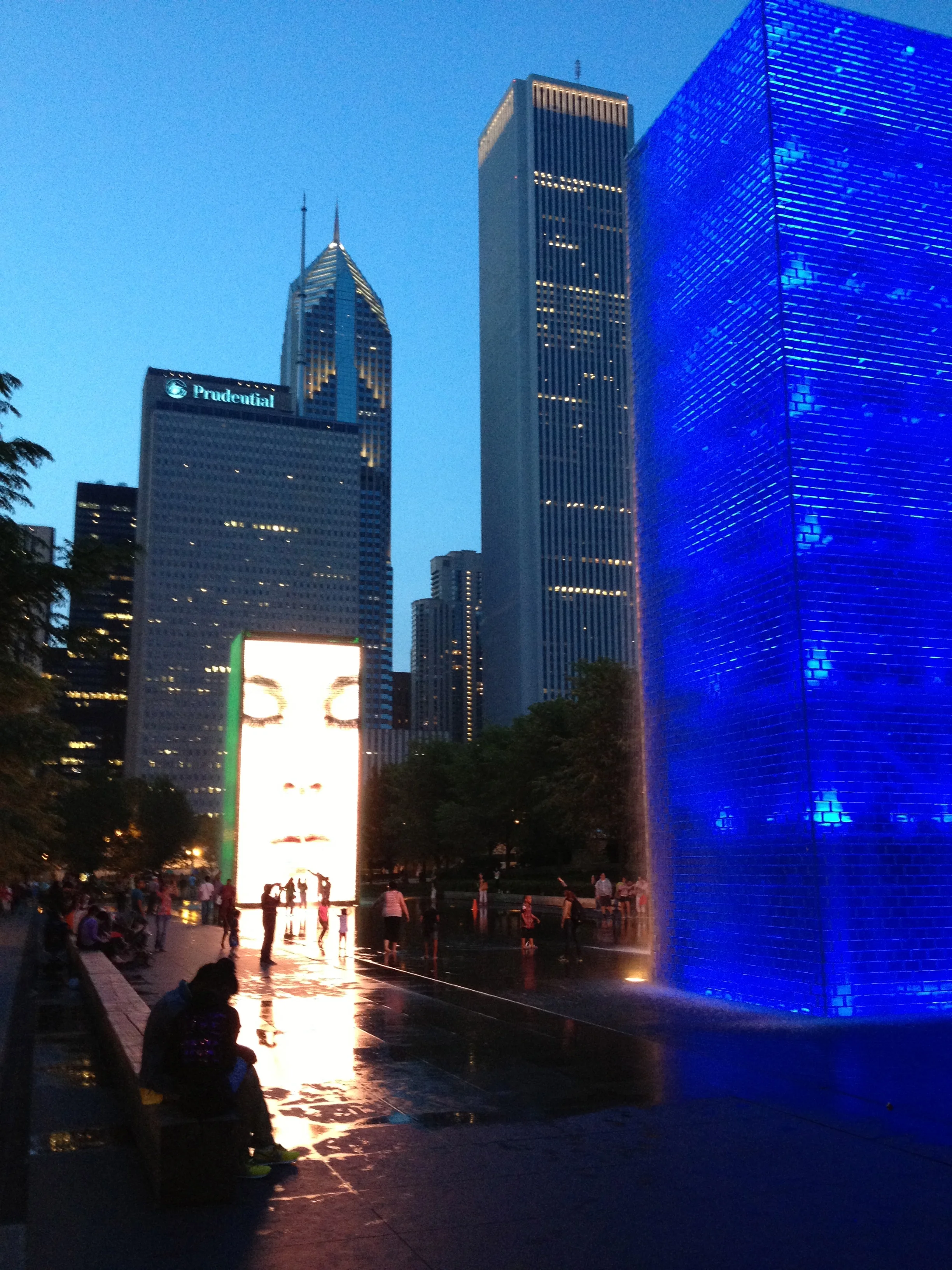 Even at night the Crown Fountain attracts hundreds of people of all ages and backgrounds to play and interact with the LED faces and the wading pool. 