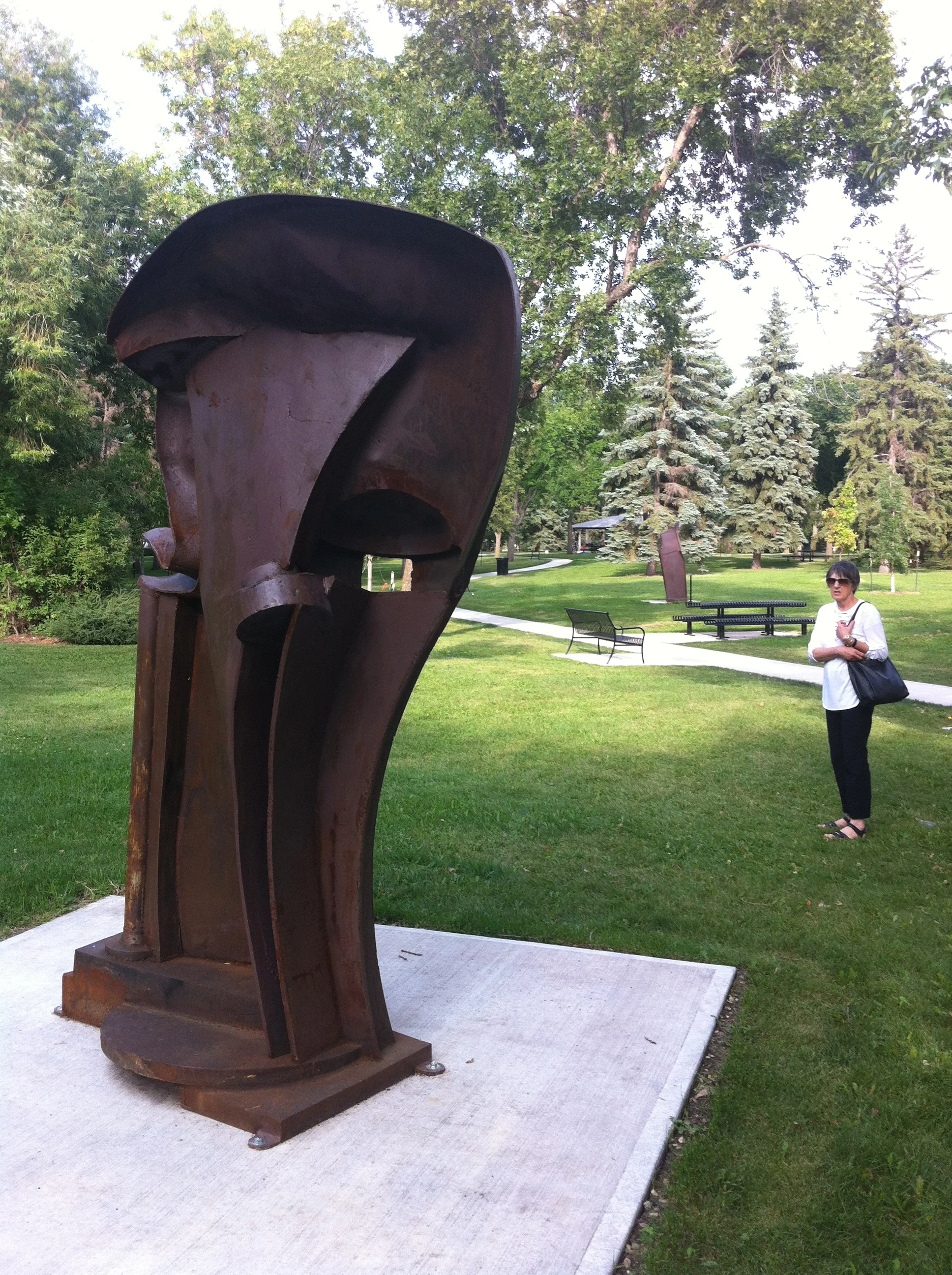 Gaekwar of Baroda (1999) by Peter Hide, mild steel. Gaekwar of Baroda is particularly inspired by the Indian sandstone reliefs of the Bordon Collection housed at the Glenbow Museum in Calgary. Sculptor Peter Hide states, "I was attracted by the voluptuous curves of the human body played off against the massiveness and rigidity of architectural forms. I wanted to try and bring some of these qualities into steel sculpture. 
