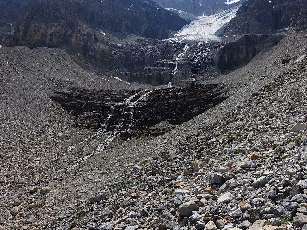 Stanley Glacier with two waterfalls that are the beginning of Stanley Creek. We hiked up to the top of the first waterfall. Note the loose and uneven rocks in the right corner - I am surprised someone didn't at least sprain their ankle. 