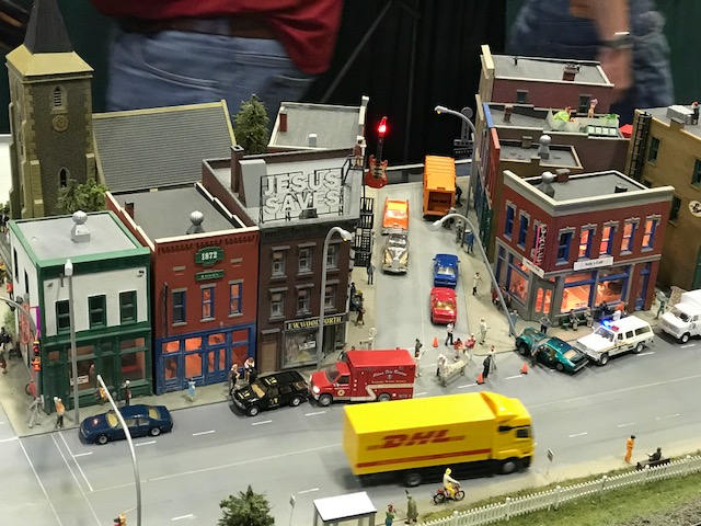 Look carefully and you will see the cafe is on fire and someone is being taken to the ambulance. There is more rooftop activity and of course the "Jesus Saves" sign. 