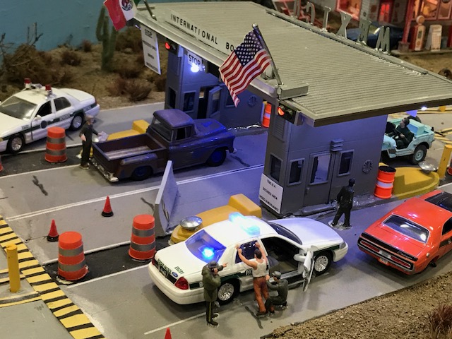 This search is happening at a US/Mexican boarder crossing, while next to them immigrates are crawling under the fence (see next photo). 