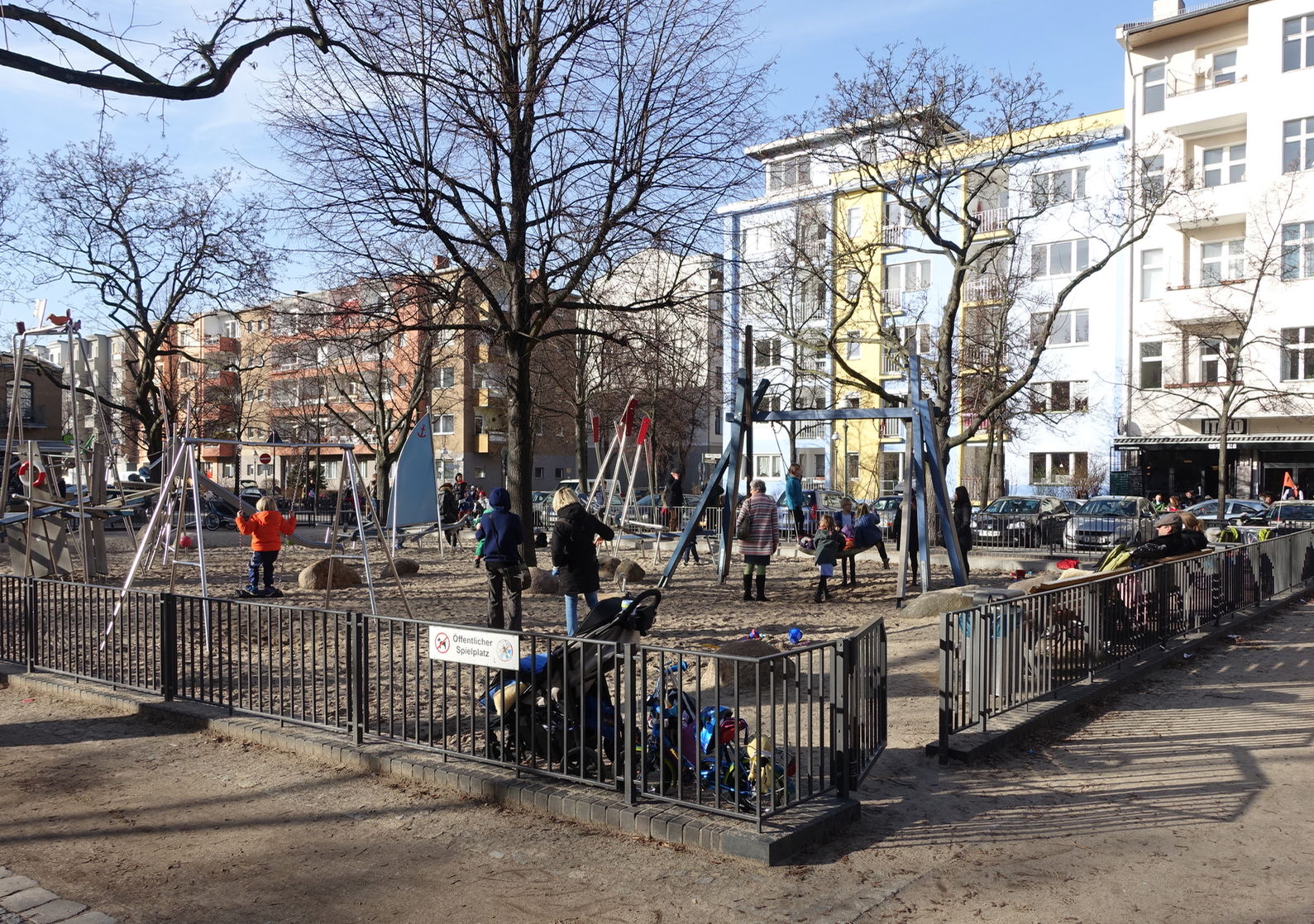 Instead of backyard, kids play in the local playground which is surrounded by mid-rise residential blocks. 