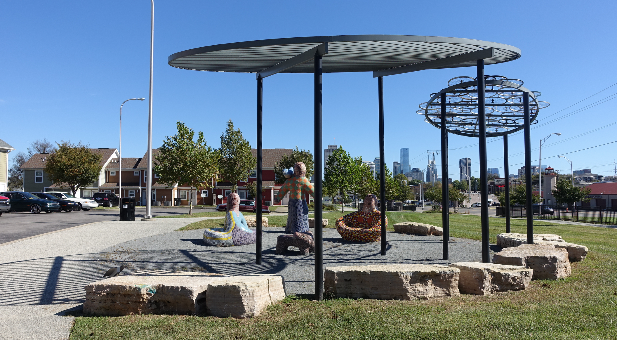 Fun little park incorporates folk art figures with bike rim sun screen. 