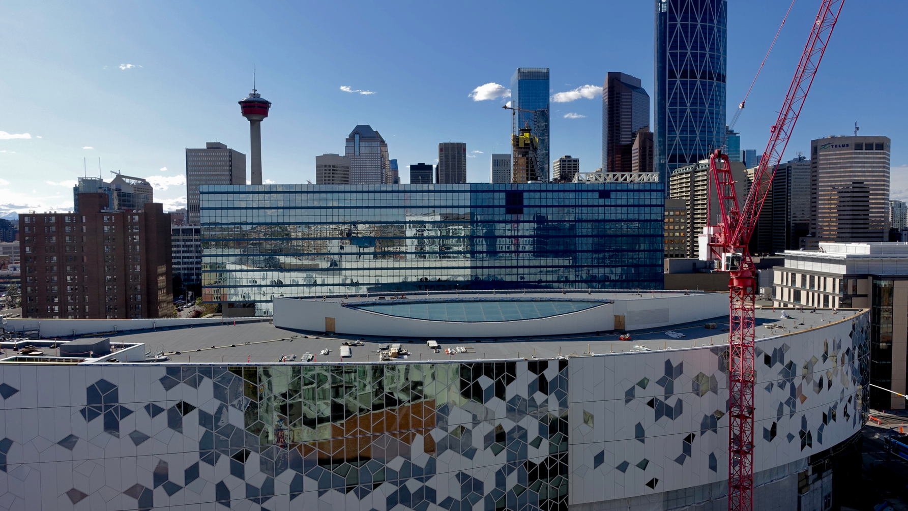 A view of Calgary skyline from the N3 condo rooftop patio with the new Central Library in the foreground. 