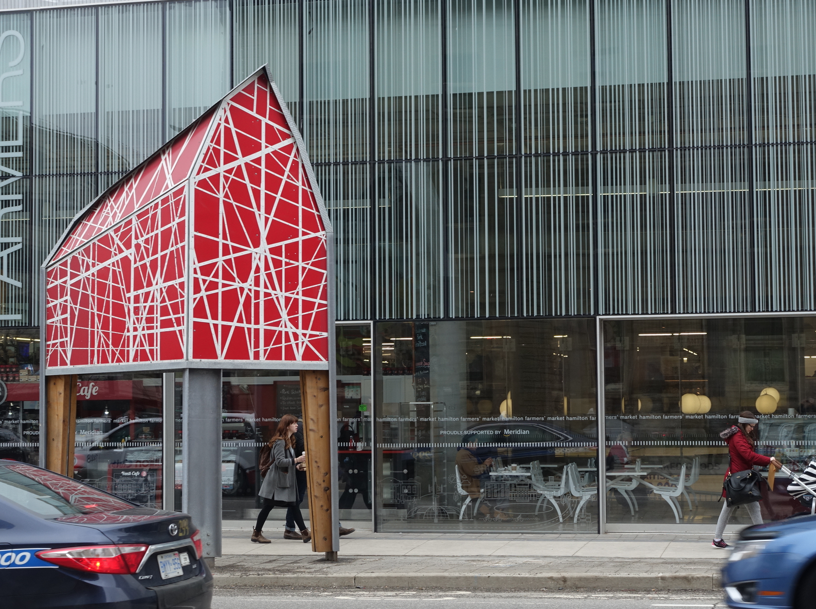 This barn-like sculpture outside of the Hamilton's Farmers' Market adds a sense of playfulness to the pedestrian experience. I love contrast between the chaotic lines of artwork and the ordered linear lines of the market windows. A nice metaphor for entropy of urban living.