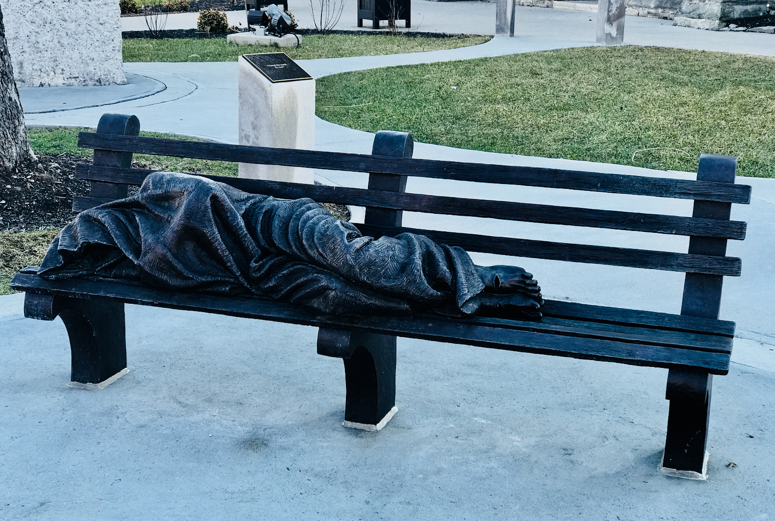 When I first saw this piece I thought it was a real person sleeping on the bench. This is outside St. Patrick's Roman Catholic Church. 
