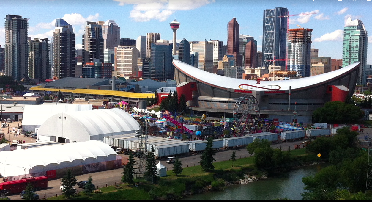 Calgary's Saddledome arena with downtown skyline in the background.