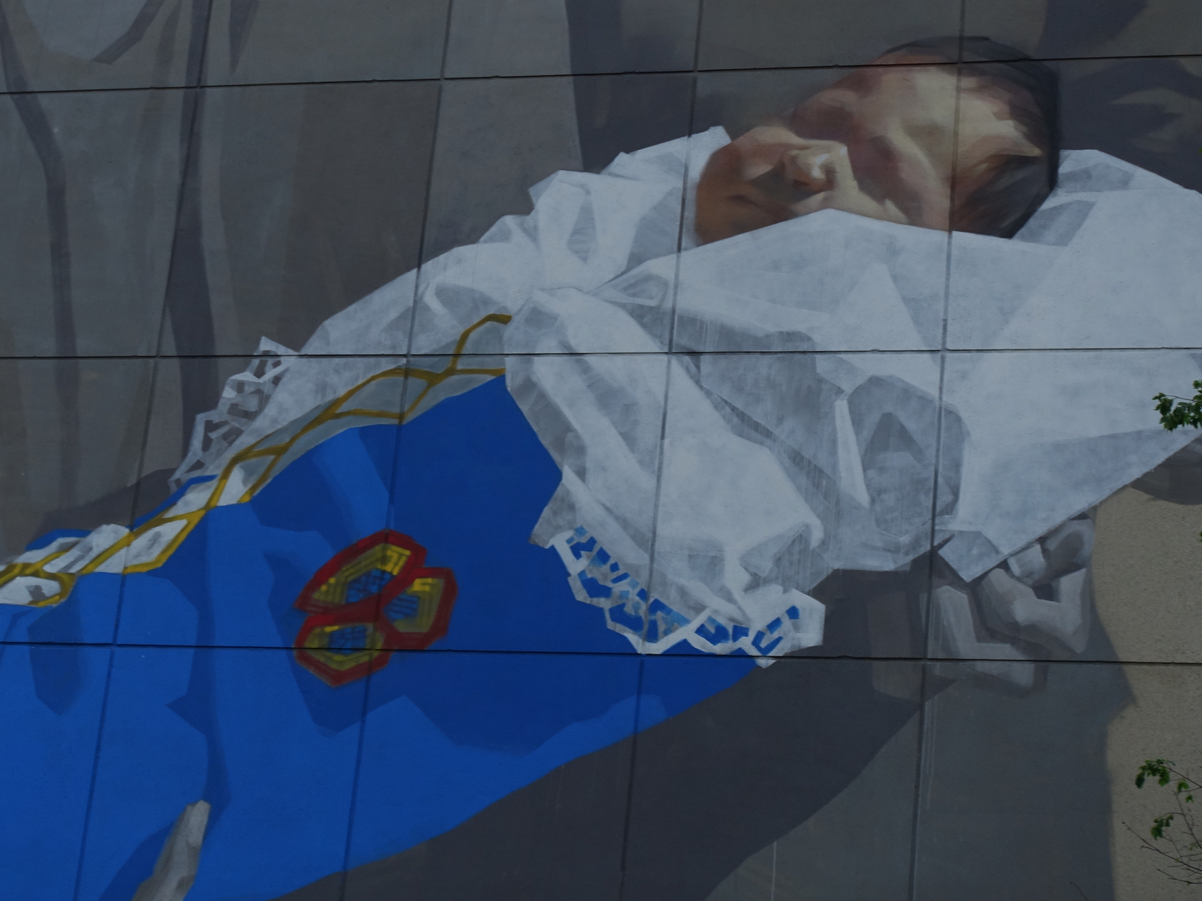 I think it is also very fitting that the piece is on the side of the First Nations Bank building given its First Nation references. The red ribbon in the mother's hair is meant to commemorate missing and murdered Aboriginal women and girls. Note: The piece is part of the City of Saskatoon's Placemaker program for public art. It cost $15,000. Yes this is a real family from the Yellow Quill First Nation, 195 km east of Saskatoon. 
