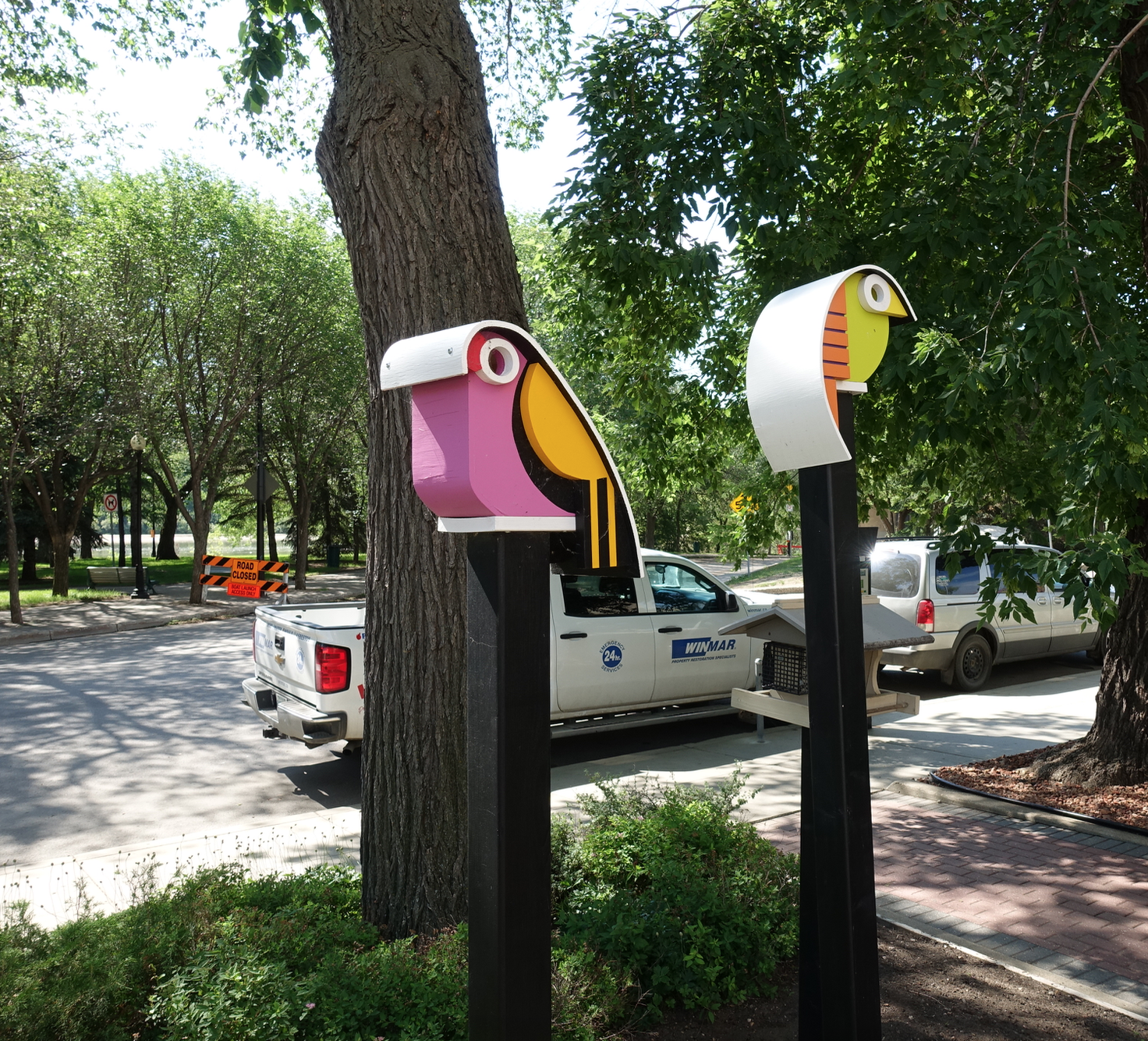You will find these two colourful birdhouses outside of JR's birdhouse workshop at the corner of Spadina Cr. and 20th St. E.