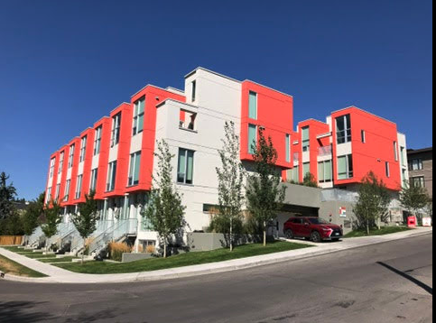 The designers of this is small condo project in the Marda Loop used colour to create not only a playful rhythm but to add the illusion of huge windows. To me this is a happy building.