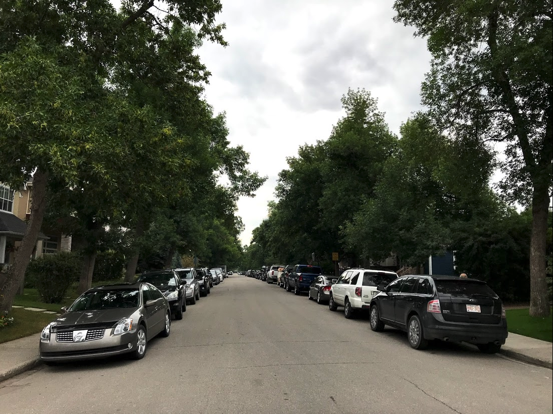 A typical inner city street in Calgary is lined with cars evenings and weekends even though every house has a garage or parking pad in the back alley.