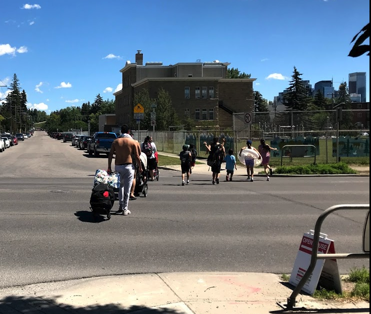 This family is off to the Riley Park wading pool.