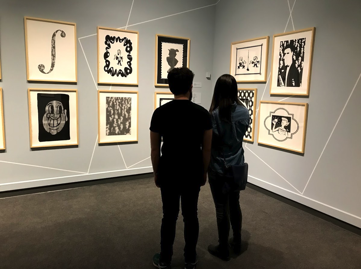 Couple enjoying Chris Cran’s fun new works.