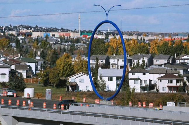 Travelling Light aka Giant Blue Ring is a street lamp installed in the middle of a bridge on a busy highway away from any pedestrian traffic.