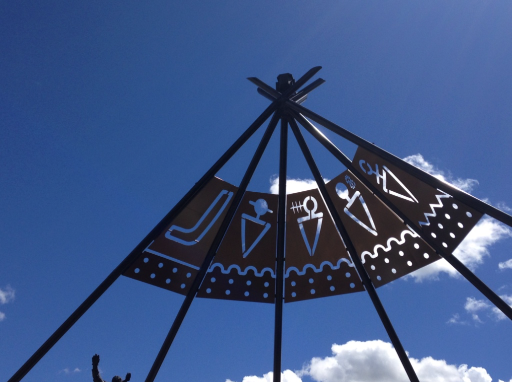 Stampede Park has numerous murals and sculptures scattered throughout the park. At the entrance to the Park from the LRT Station on Macleod Trail is a contemporary tipi inspired sculpture - the semi-circle design depicts the historic iconography of the Kainai, Piikani, Siksika, Stoney Nakoda and Tsuut’ina nations. The sculpture sits on the original site of Stampede’s Indian Village which was Sun Tree Park.