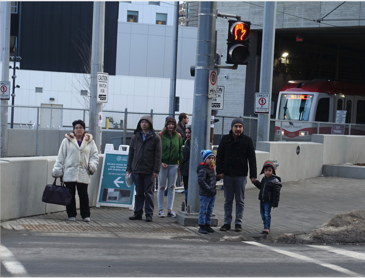 On the other side of 3rd St SE. the small ramp area is made even worse with a sandwich board, concrete half-wall and street signal post.