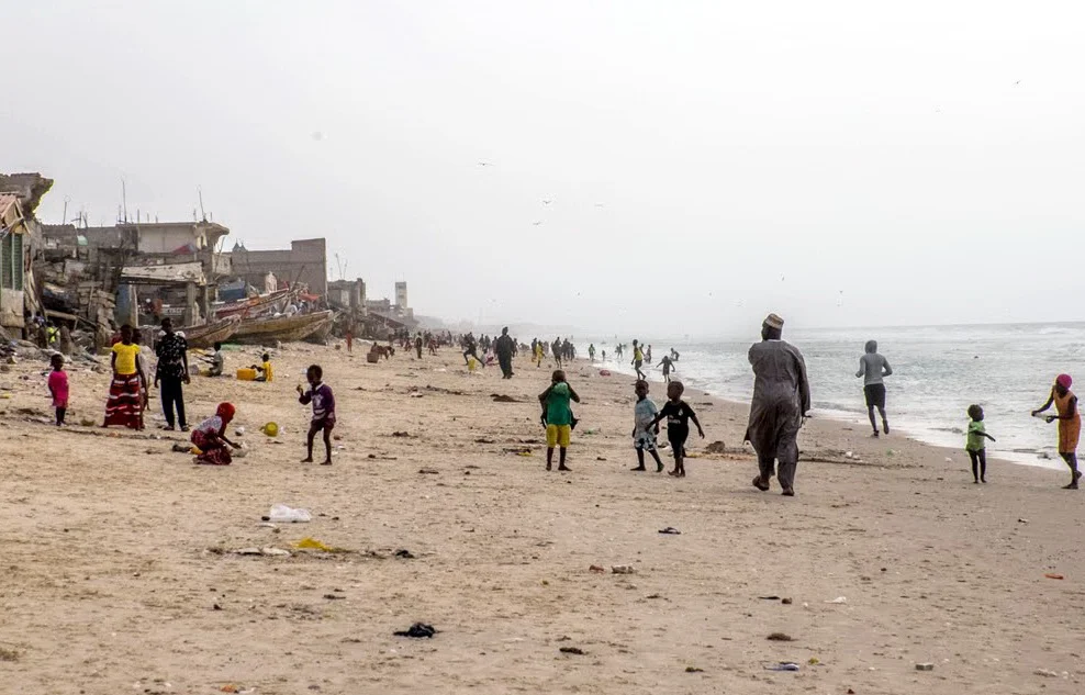 The fishing beach, St. Louis, Senegal. Hundreds of dilapidated houses, little more than shacks, crowd the edge of the beach in St. Louis, often with fishing boats tucked between them well above the tide. The children mainly play on the beach as there is virtually no other open space in the fishing village. Adults seem to commonly use the beach as a sidewalk to visit friends and neighbors. We were tolerated, but not really welcome on this garbage-strewn beach. We had hoped to see the boats coming in and unloading their catch, but our timing was off.