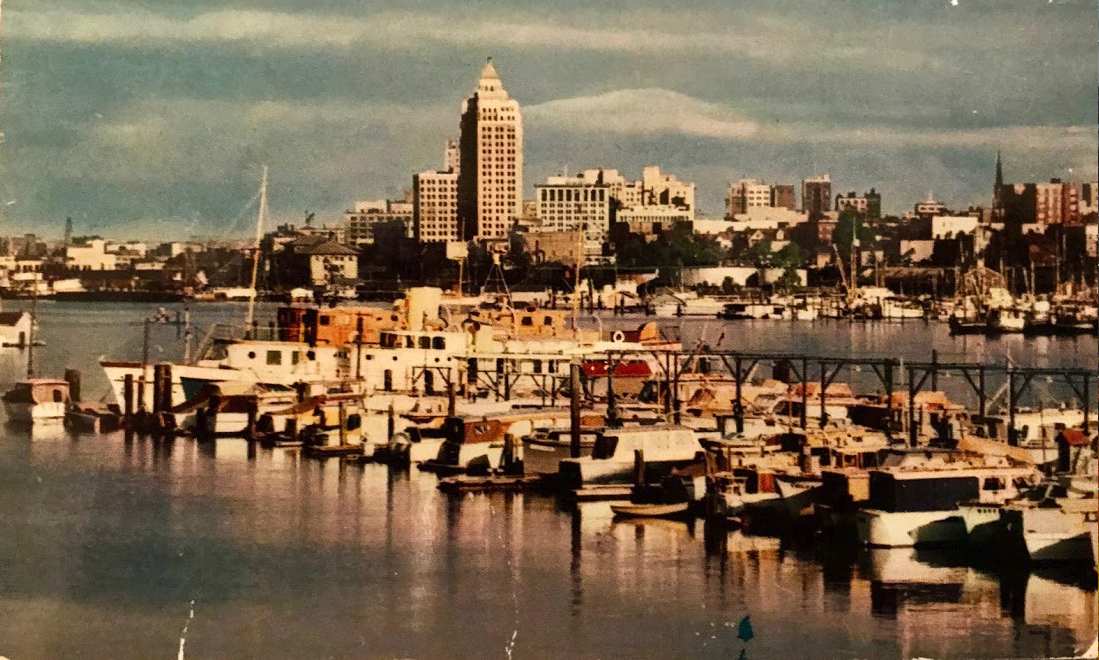 Vancouver Water Front View taken from Stanley Park showing Coal Harbour, In the foreground are boats belonging to the Burrard Yacht Club. In the background can be seen the Marine Building, the tallest in Vancouver, and part of the skyline.