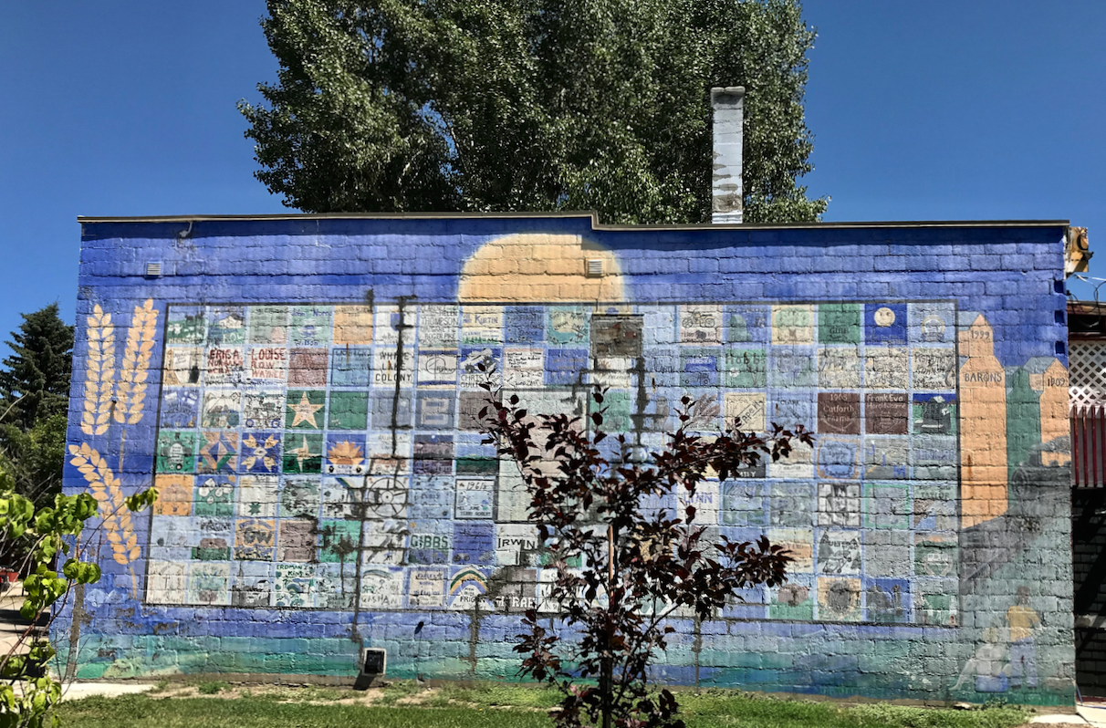 The quilt-like mural is composed of blocks each with a name of a local family.