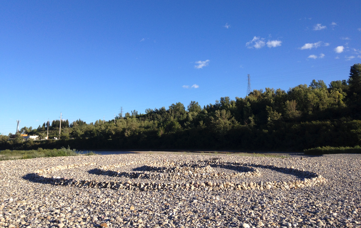 The huge gravel bar in the Bow River is a popular spot for people to create rock formations like this one.
