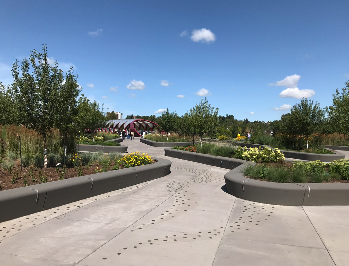 A bit further and you are at new West Eau Claire Park at the south entrance to the iconic Peace Bridge designed (the latter by world renowned bridge designer Santiago Calatrava). The $10.6 million park (30% of the budget was used for flood mitigation) designed by Calgary’s O2 Planning + Design is meant to simulate a river delta with cyclist, runners, walkers and now e-scooters being the “water” flowing off the Peace River onto the Bow River pathway using different streams. The park also contains a subtle public artwork was created by Calgary-based artists Caitlind R.C Brown and Wayne Garrett who installed 12,000 brass “survey monuments” i.e. loonie sized brass coins throughout the delta each have simple messages collected by asking Calgarians along the pathway “where they are going or where they want to be?”