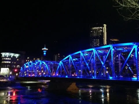 As you stroll along the RiverWalk, you will also pass by the 1910 Reconciliation Bridge, originally named the Langevin Bridge after Hector-Louis Langevin, a founder of Canada’s confederation and one of the architects of the nefarious residential schools. It was decided in 2017, as part of Canada’s attempt to reconcile the injustices done to First Nation peoples to rename the bridge. The bridge is beautiful in the evening when it is lit up.