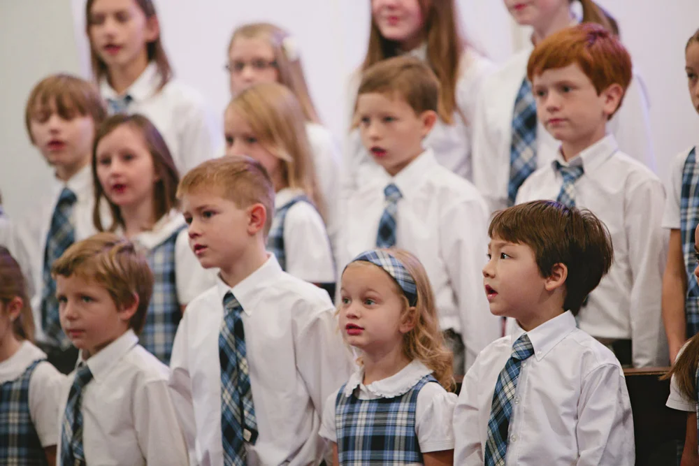 The All School Choir performs our National Anthem.