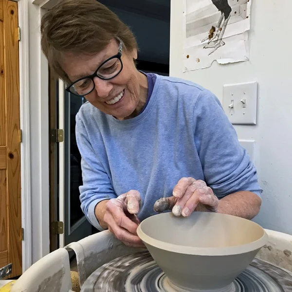 Caroline Montague Wet spinning clay on the wheel:slurry sliding through fingers, plastic and stretching, responds to centering and forming. A shape emerges; echoing movement and rhythm of creeks, tides, Sun and Moon. I love this Earth. Stars in the night, the alchemy of the gas kiln fire and celebrating this atmosphere among other potters, sustains my creativity.